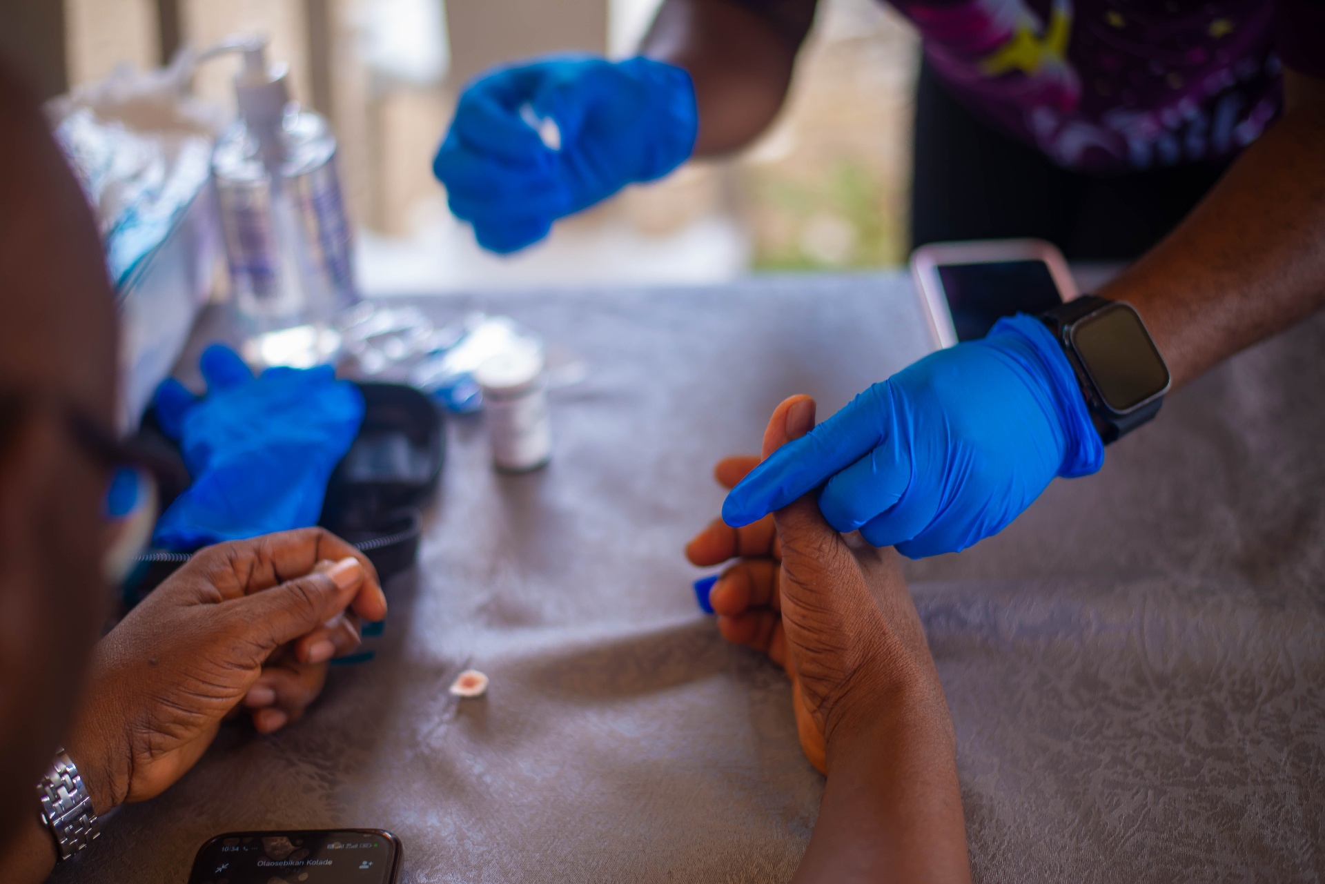 MSCF team running glucose tests with gloved hands