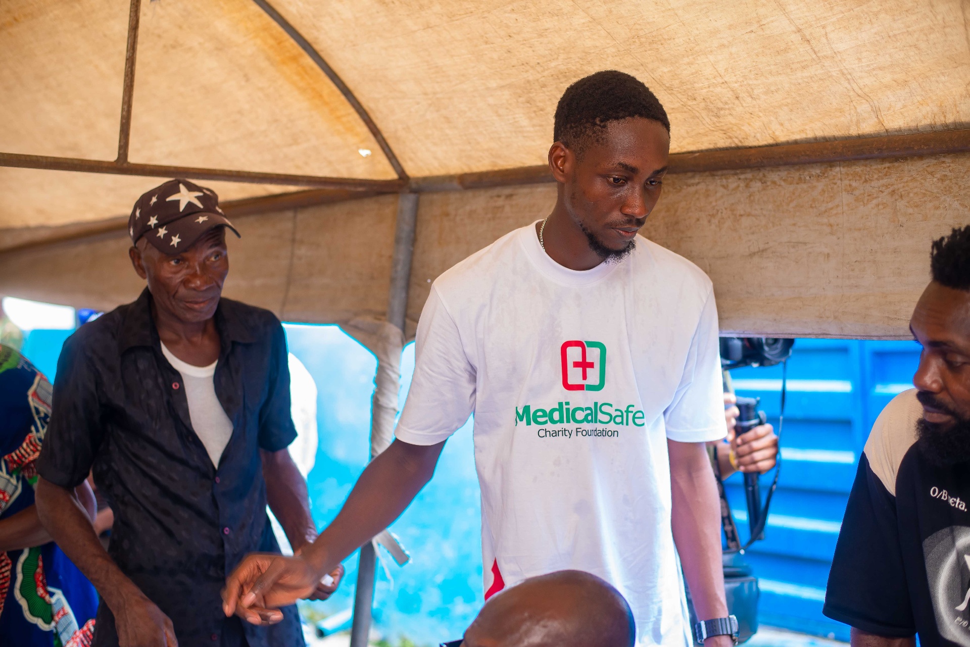 MSCF volunteer assisting an elderly patient
