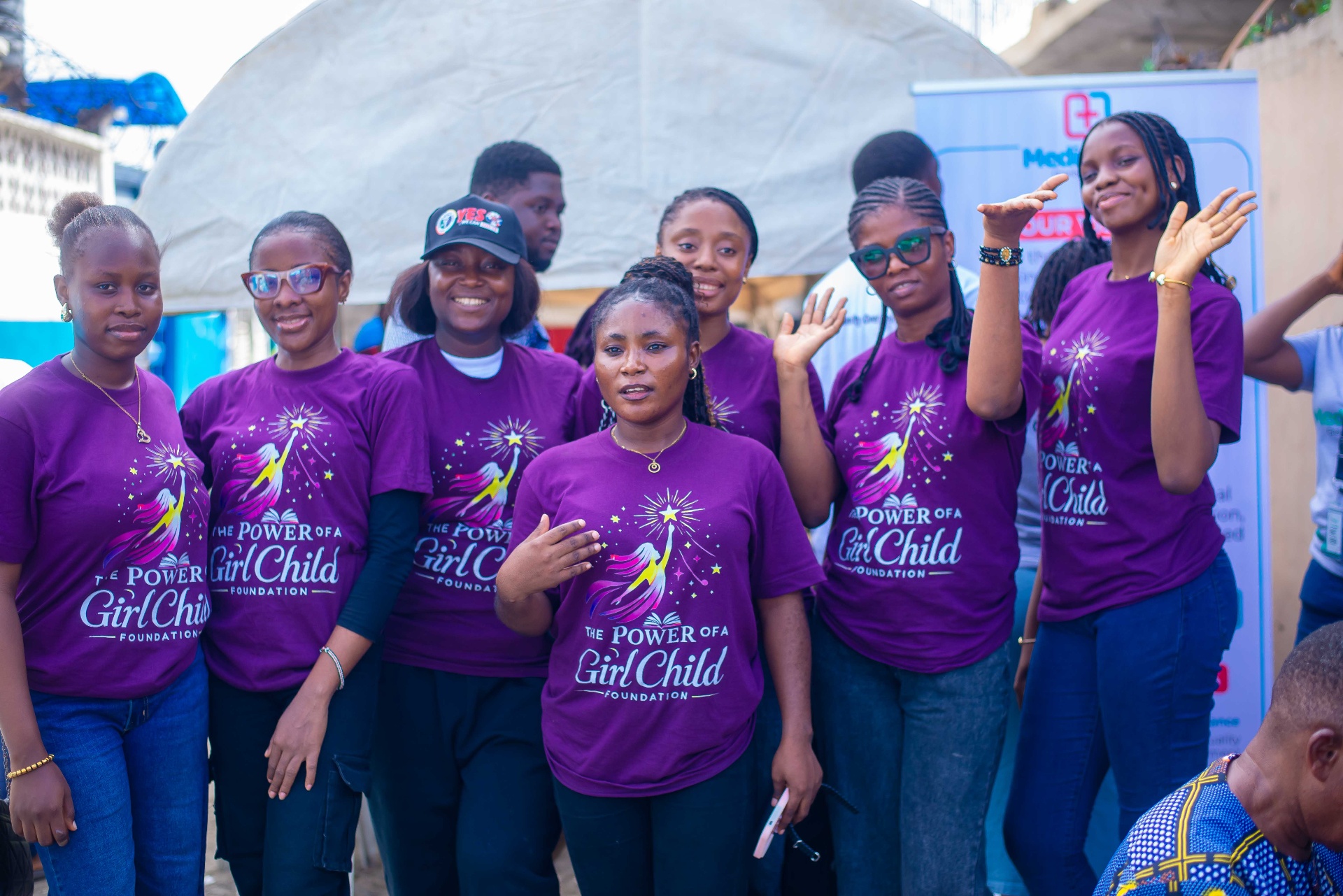 Power of a Girl Child Foundation volunteers waving