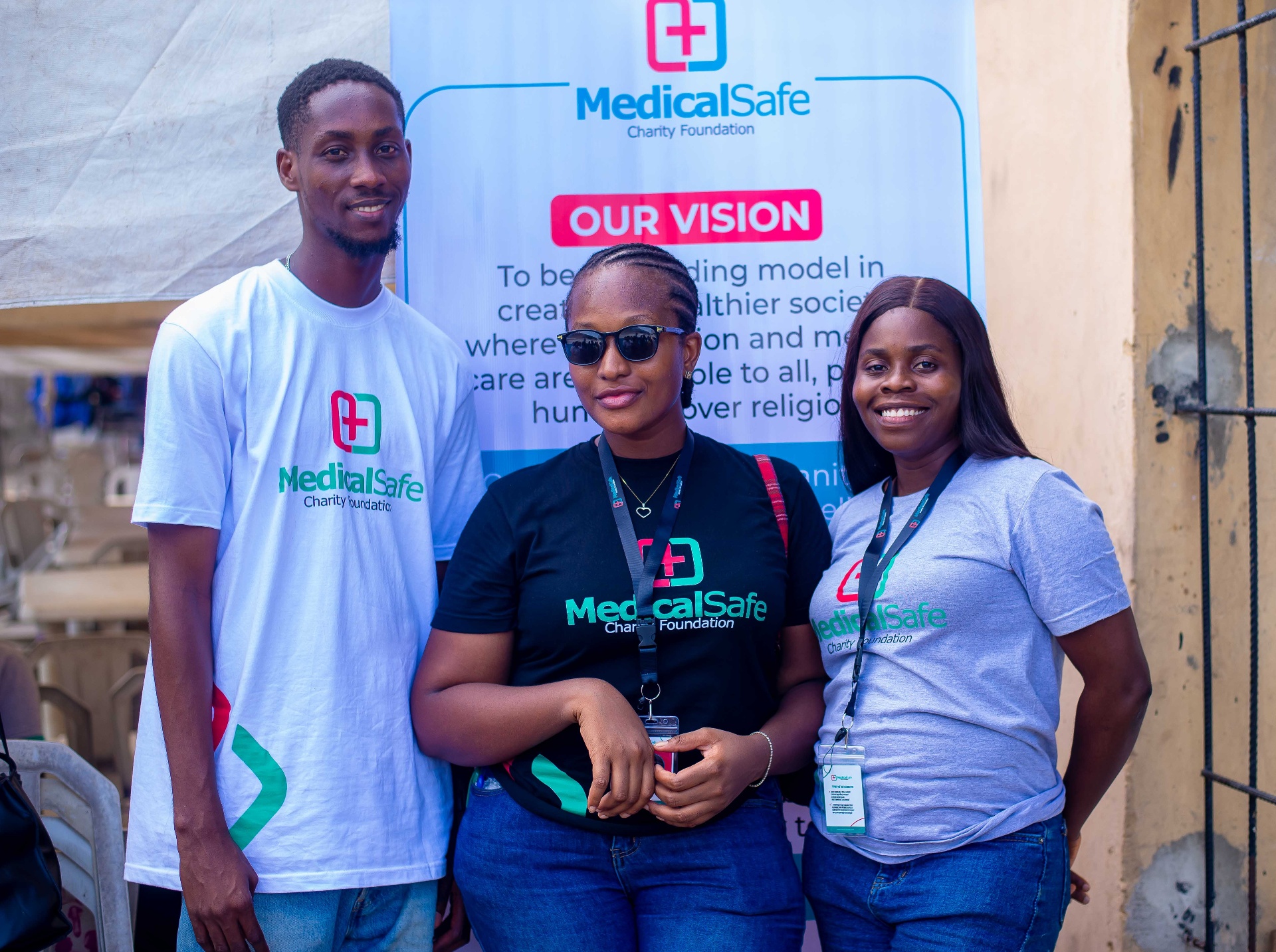 Three MSCF volunteers smiling at outreach